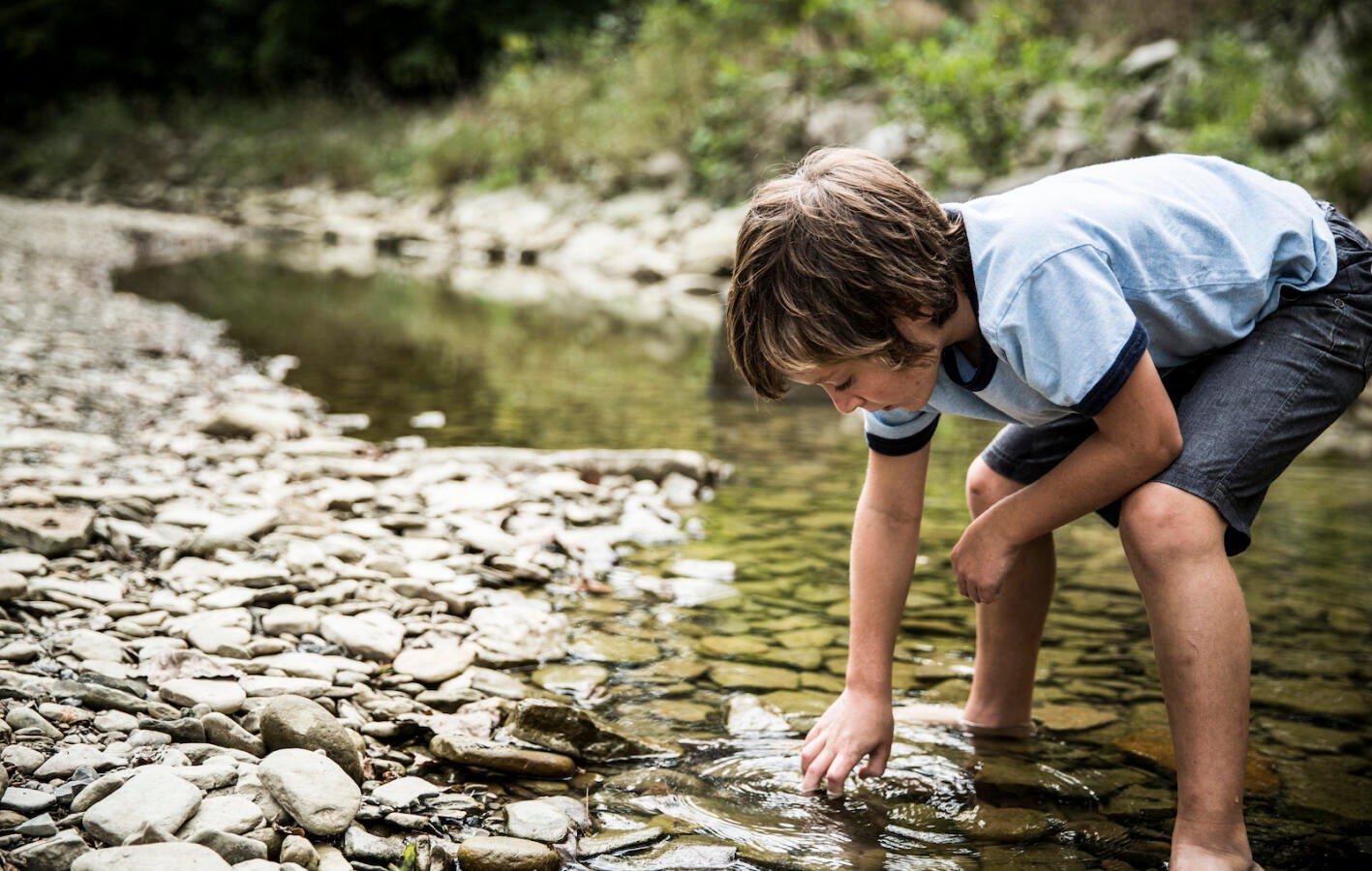 Boy exploring in stream